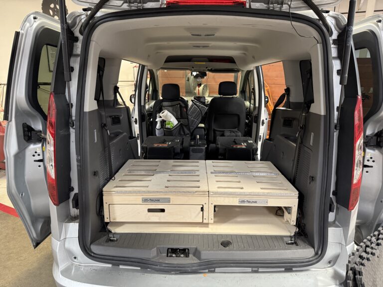 Custom Trunk Mate van set-up with sturdy wooden storage drawers perfectly fitted behind the front seats—ready to organize your gear and keep road trip essentials tidy.