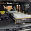A foldable single Trunk Mate sleeping platform with one spacious drawer is set up in the back of an SUV, showing labeled dimensions and adjustable height features for a perfect custom fit.