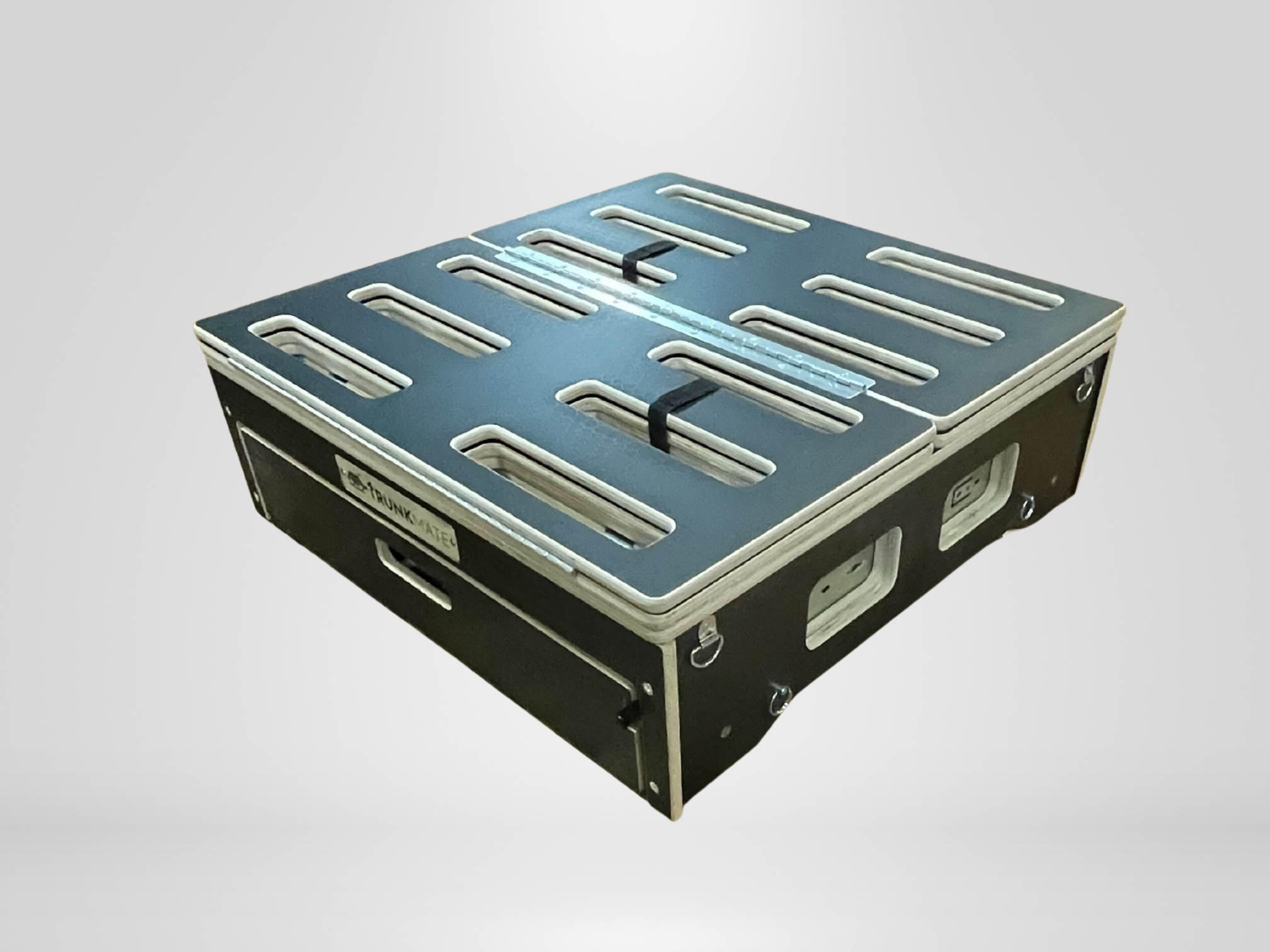 Rectangular black storage crate with metal edges, top vents, side handles, and a "SKYMARK AIR" label—tough Trunk Mate gear.