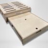 Trunk Mate Sleeping Platform shown with its signature slotted top, easy-grab cutout handles, and a smoothly sliding drawer for organized storage—all crafted from light, durable wood.
