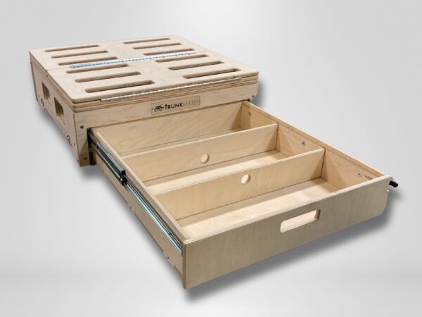 Trunk Mate Sleeping Platform storage drawer unit with convenient dividers, easy-grab cut-out handles, and ventilation slots on the top—shown partially pulled out for smart access.