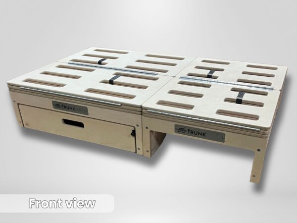 A Trunk Mate wooden storage platform featuring ventilation slots, a spacious pull-out drawer, sturdy handles, and secure straps—everything you need for organized car camping. Shown from the front with the bold "TRUNK MATE" logo visible against a simple backdrop.