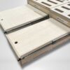 Two wooden sliding panels on sturdy metal rails, smoothly extending from the Trunk Mate modular sleeping platform, spotlighting our signature easy-slide design against a simple backdrop.