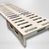 Trunk Mate foldable wooden bed platform with sturdy slats, shown partially unfolded—simple, portable sleep setup made easy.