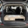 An SUV trunk with a Trunk Mate wooden storage platform and organized compartments set right behind the rear seats.